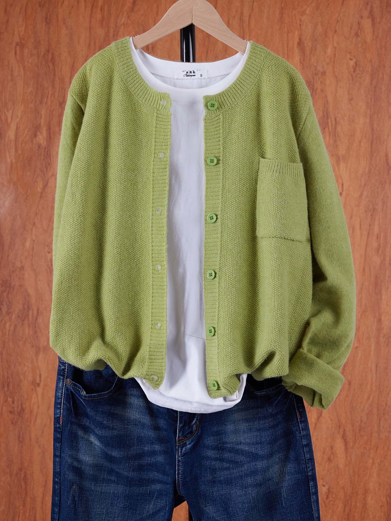 Light green round-neck cardigan with button front and side pocket