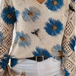 Floral knit pullover sweater close-up in cream with blue flowers, V-neck and crochet sleeves