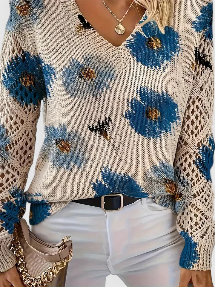 Floral knit pullover sweater close-up in cream with blue flowers, V-neck and crochet sleeves