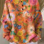 Orange floral print pullover sweater with long sleeves and henley button placket