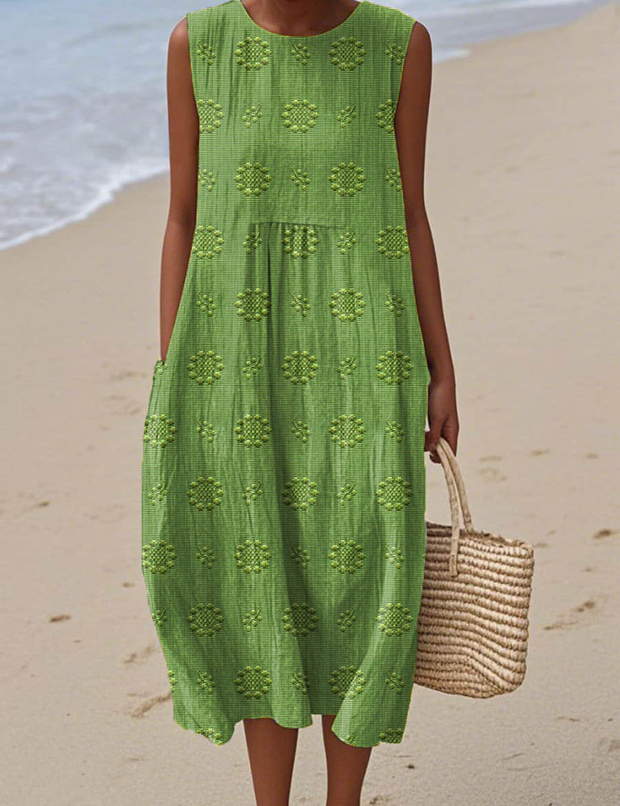 Green sleeveless beach dress with textured floral pattern and tiered skirt
