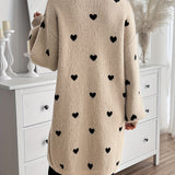 Back view of heart-pattern knit cardigan, long sleeves, light beige knit with dark hearts.