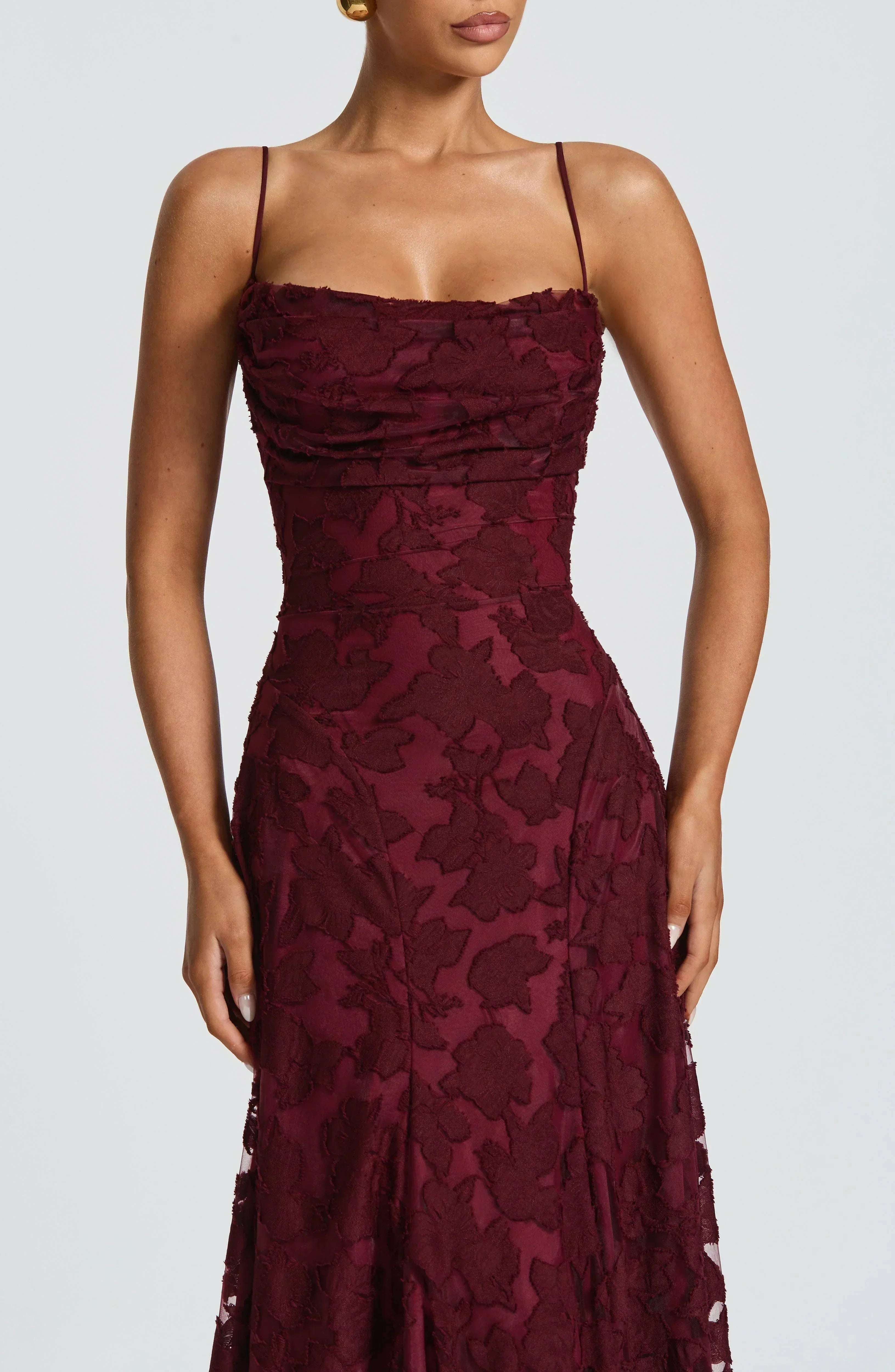 Burgundy lace maxi dress with spaghetti straps and fitted ruched corset-style bodice
