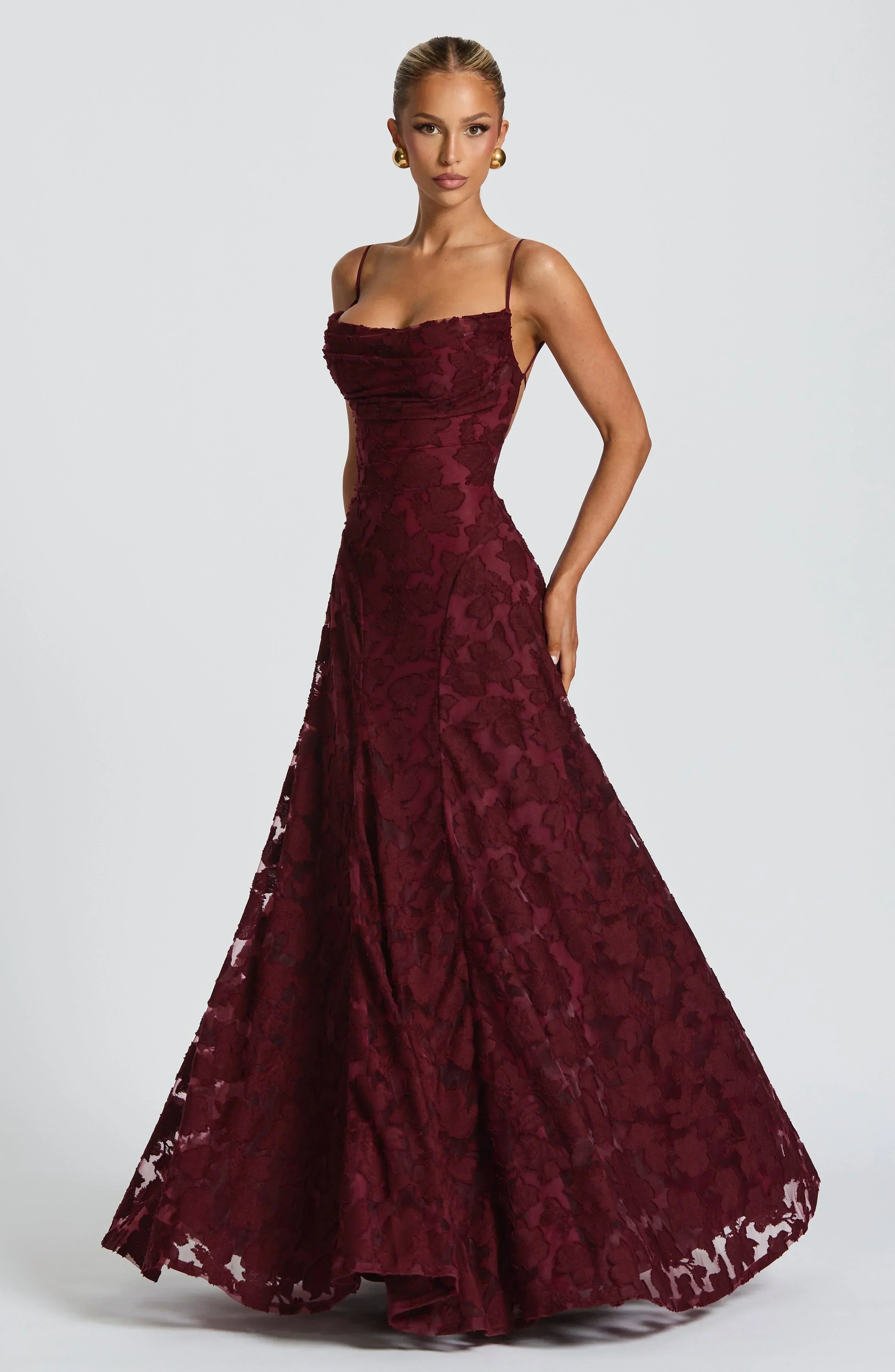Burgundy lace maxi dress with spaghetti straps and flared tiered skirt hem