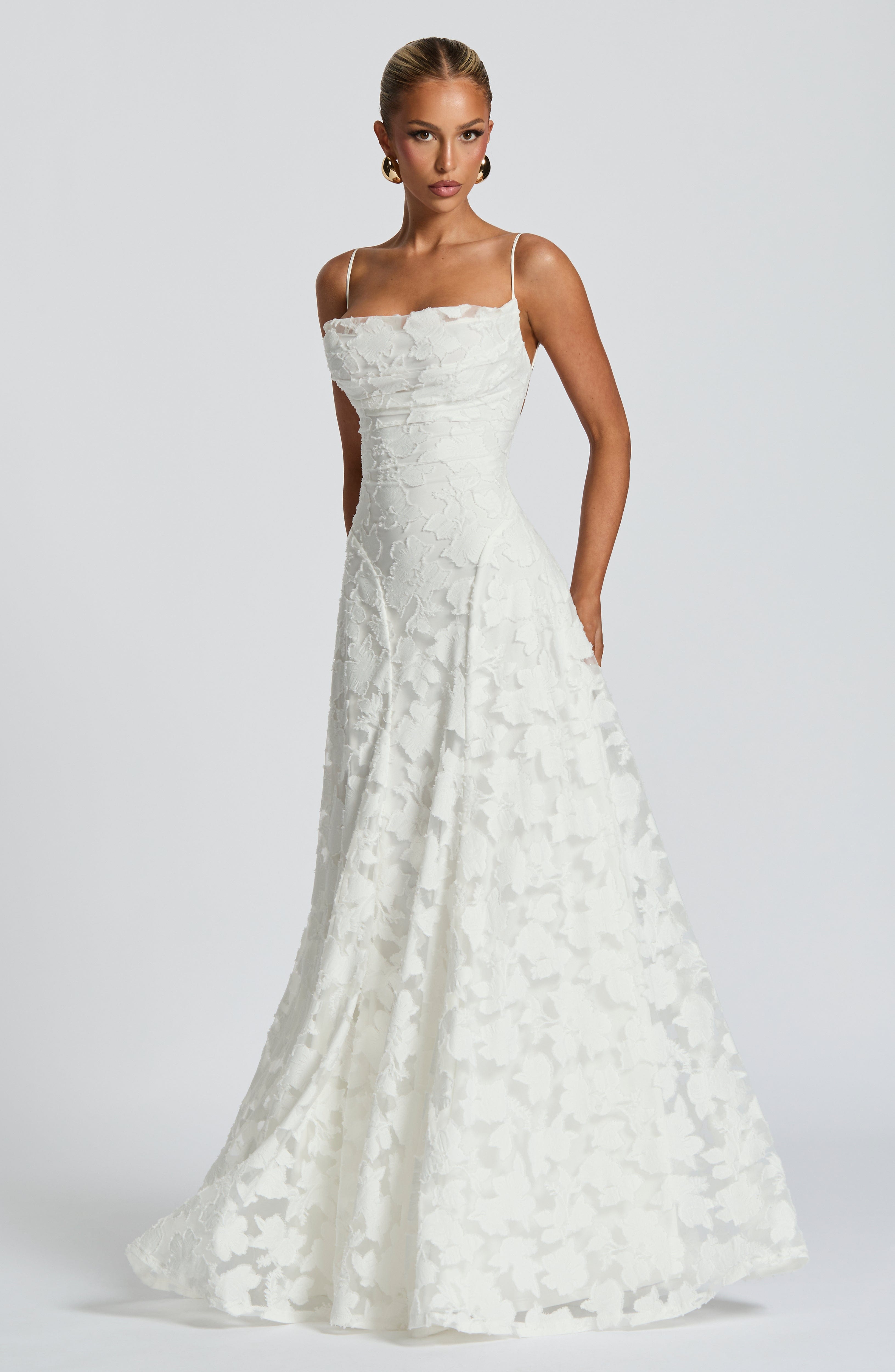 Ivory lace maxi dress with spaghetti straps and flowing flared skirt