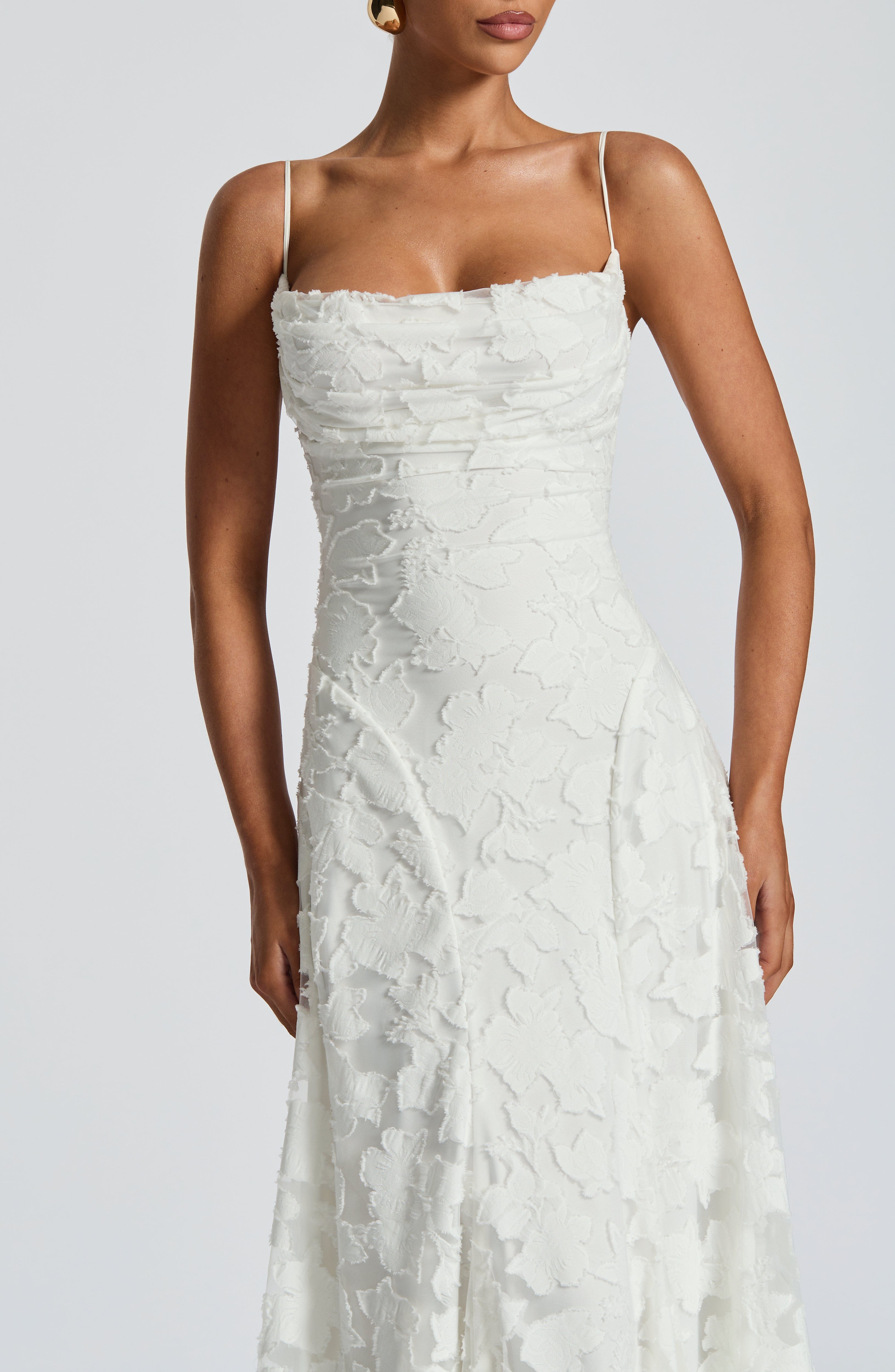 Ivory lace maxi dress with spaghetti straps and textured sweetheart bust