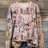 Botanical print pullover hanging on hanger, crew neck, long sleeves with ribbed cuffs