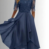 Navy lace dress with embroidered lace sleeves and layered ruffle midi skirt, flowing hem