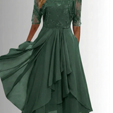 Green lace dress with sheer three-quarter sleeves and floral embroidery, layered midi skirt