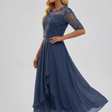 Navy lace dress with asymmetrical ruffled skirt detail and sheer three-quarter sleeves