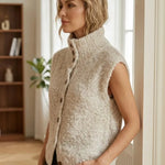 Sleeveless beige cardigan with fuzzy texture and vertical button-front detail