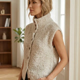 Sleeveless beige cardigan with fuzzy texture and vertical button-front detail