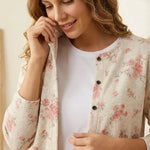Rose-print cardigan with black buttons, cream knit texture, long sleeves