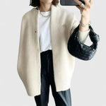 Cream fuzzy button-front cardigan jacket with long sleeves and side pockets