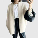 Cream fuzzy button-front cardigan jacket with long sleeves and side pockets