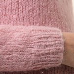 Light pink fuzzy knit sweater sleeve cuff with ribbed texture