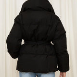 Black padded hooded jacket with tie belt, shown from the back, long sleeves.