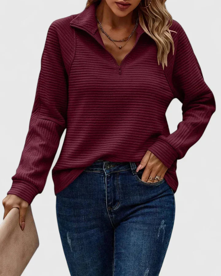 Burgundy ribbed half-zip knit sweater with long sleeves.