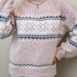 Light pink knit sweater with white fair isle band and snowflake motifs, crew neck, long sleeves