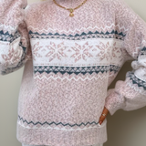 Light pink knit sweater with white fair isle band and snowflake motifs, crew neck, long sleeves