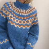 Cozy blue fair isle turtleneck sweater with orange and cream patterns, long sleeves
