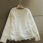 Cream knitted pullover with long sleeves and ribbed knit cuffs and hem