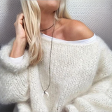 Off-white fluffy knit sweater with wide neckline and long sleeves