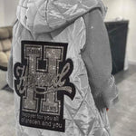 Light gray quilted hooded jacket with large back graphic and full-zip front