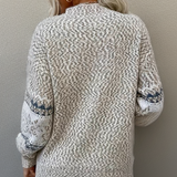 Back of cream knit sweater with textured stitch, crew neck, long sleeves, ribbed cuffs