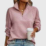 Blush pink ribbed half-zip knit sweater with long sleeves.