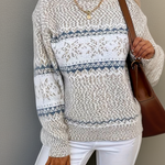Cream knit sweater with blue fair isle stripe band and snowflake motifs, crew neck, long sleeves