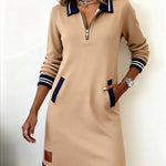 Tan long-sleeve cotton zip dress with navy striped cuffs and hem, patch pockets