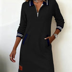 Long-sleeve cotton dress in black with half-zip, striped collar, cuffs, and hem trim