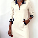 Cream long-sleeve cotton zip dress with navy striped cuffs and hem, patch pockets