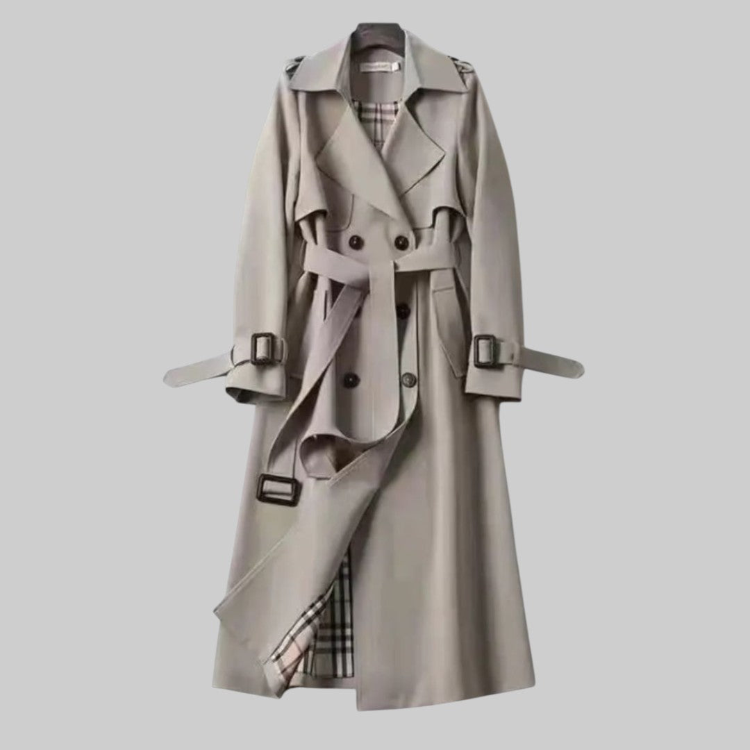 Light gray trench coat front view with belt, double-breasted buttons, and cuff tabs