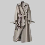 Light gray trench coat front view with belt, double-breasted buttons, and cuff tabs