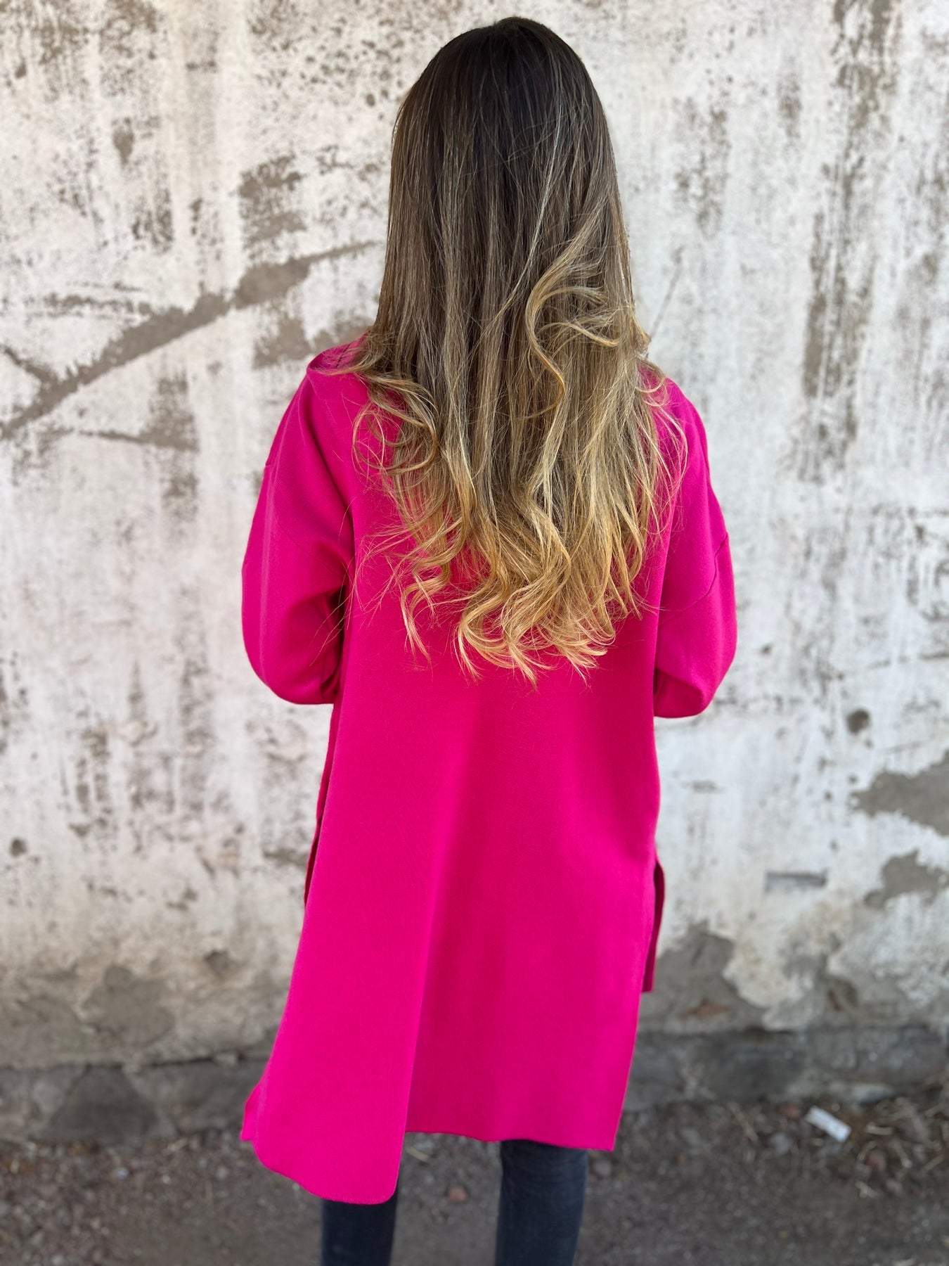 Long hooded knit cardigan, bright pink, full back view with hood