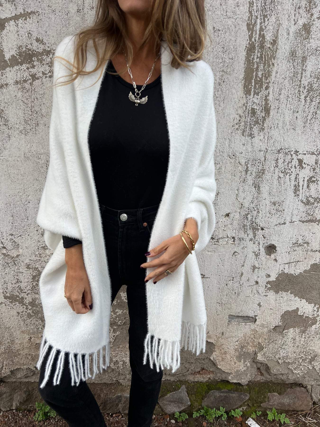 White long-sleeve wrap cardigan with fringe trim, draped open front and collar