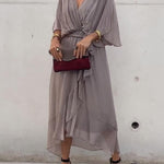 Gray V-neck midi dress with draped sleeves and tied waist belt