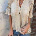 Textured V-neck blouse with short sleeves, single button closure; light beige