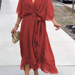 Red V-neck midi dress with draped sleeves and knotted waist belt