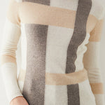 Color-block turtleneck sweater in cream with gray and beige panels, ribbed hem and cuffs