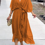 Rust orange V-neck midi dress with draped sleeves and waist tie detail