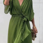 Green V-neck midi dress with draped sleeves and tied waist belt