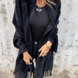 Black long-sleeve wrap cardigan with fringe hem, open front drape and collar