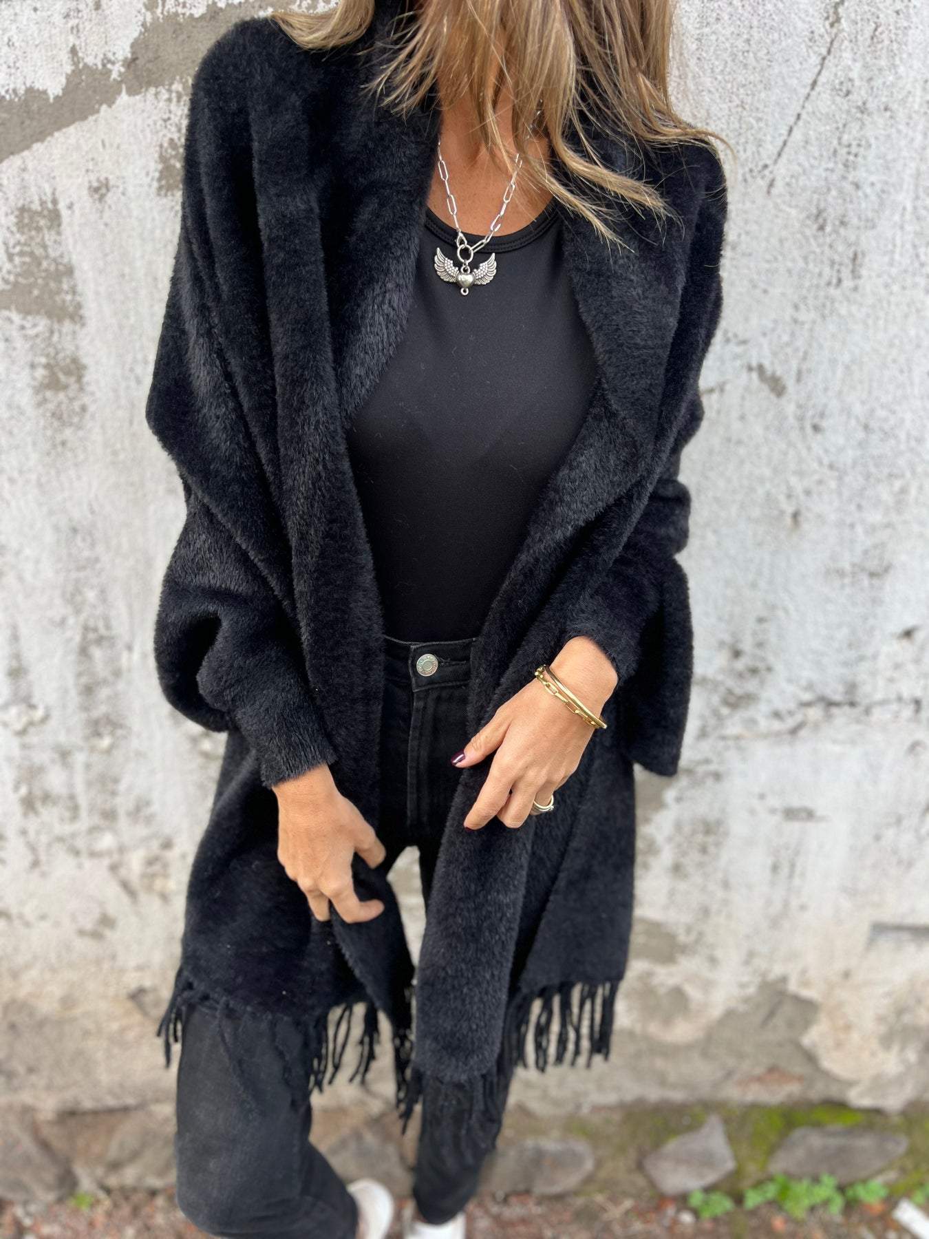 Black long-sleeve wrap cardigan with fringe hem, open front drape and collar