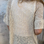 Light beige textured short-sleeve blouse with V-neck and woven pattern