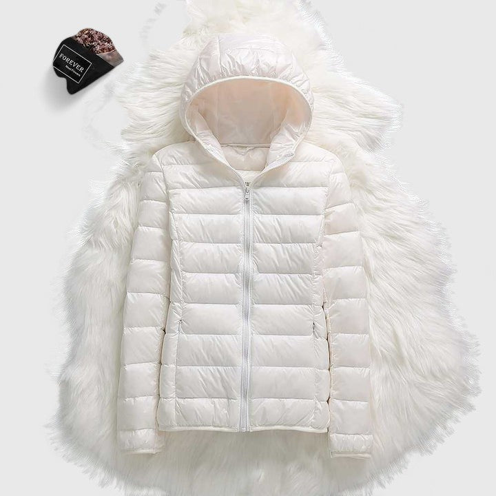 White hooded puffer jacket with full zipper and plush faux-fur trim around hood