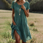 Green short-sleeve V-neck summer dress with tiny white speckle print and side slit.