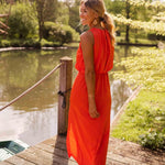 Red sleeveless midi dress, flowing skirt with side slit, sleeveless bodice